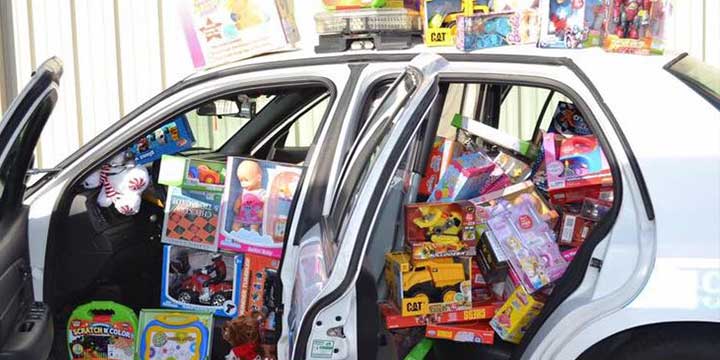 Image of a police car packed with new toys