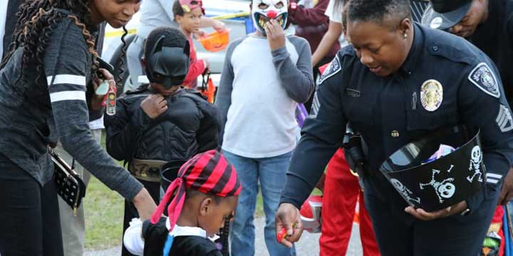 Sumter Police Officer handing out halloween candy