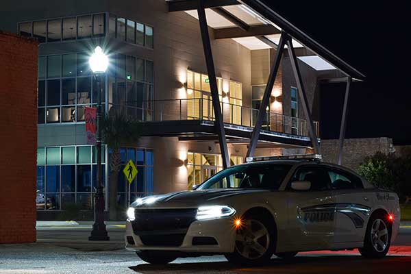 Night image of patrol car in front of SPD headquarters